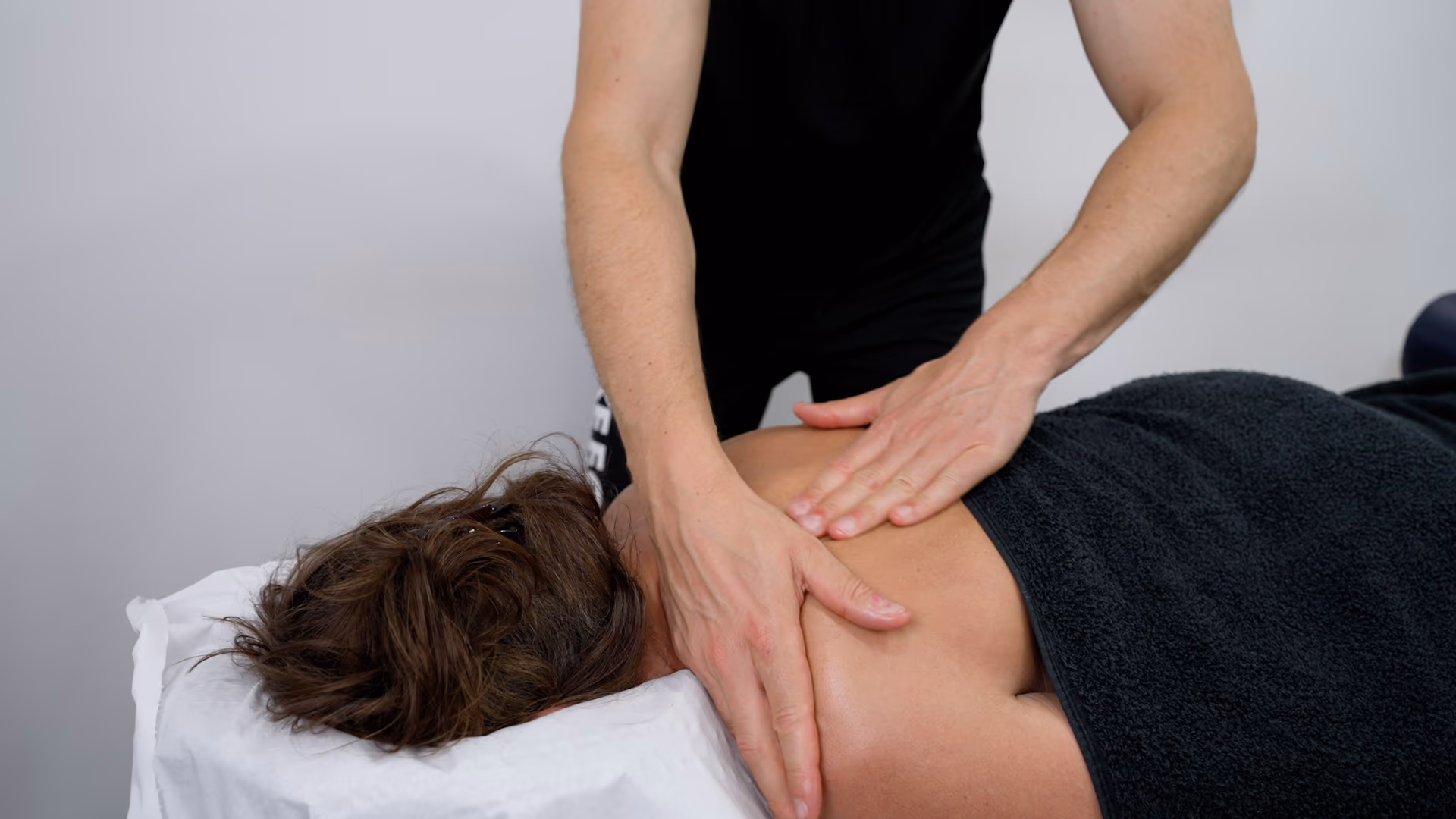 A Bodylogics physiotherapist treating a patient at home
